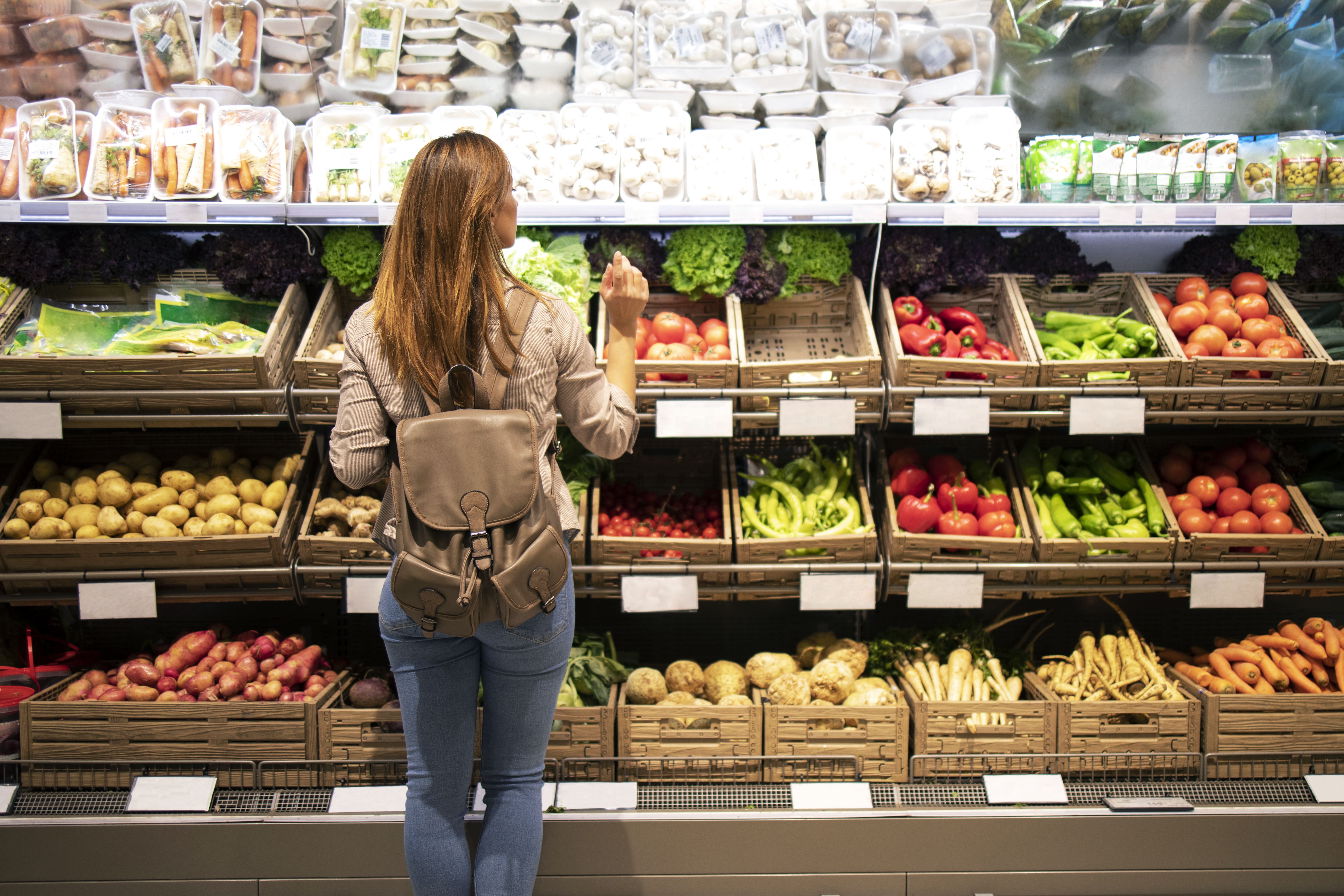 good-looking-woman-standing-front-vegetable-shelves-choosing-what-buy (1).jpg